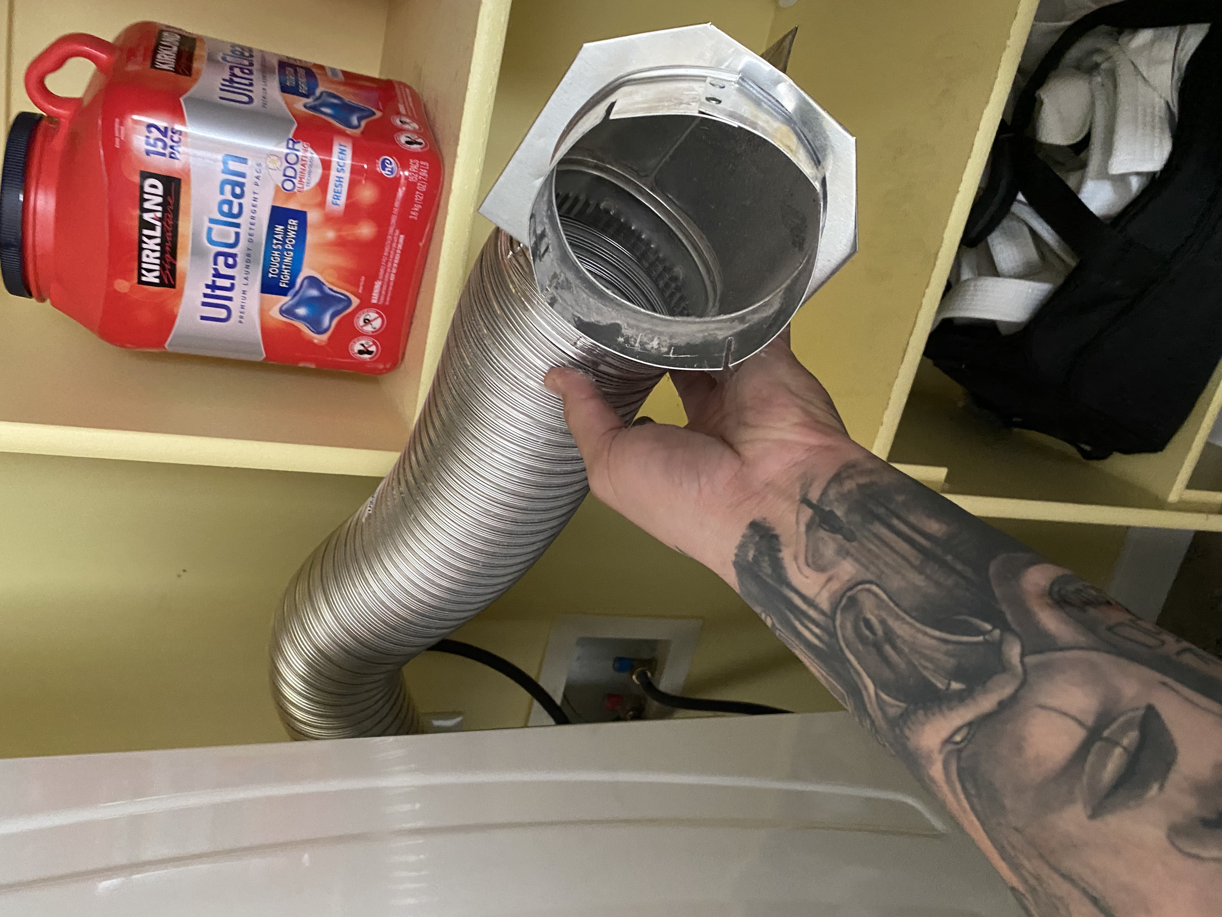 A team of uniformed corporate cleaners inspects a commercial kitchen sink with a clogged disposal. The image highlights their efficient and professional service, suggesting a quick resolution to disaster cleaning needs and preventing further disruption to business operations.