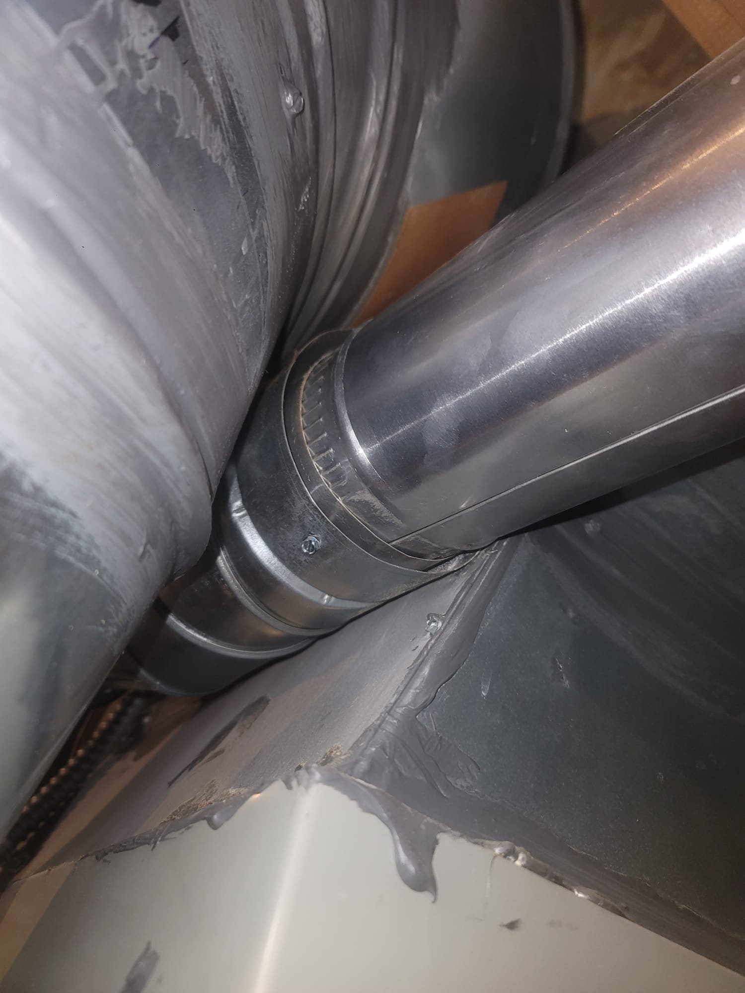 A sparkling clean window reflects a lush green lawn, subtly hinting at the water softening system inside, ensuring spotless windows and efficient energy use. Like maintaining a water softener, energy-efficient windows require care, but both investments ensure long-term benefits and savings.