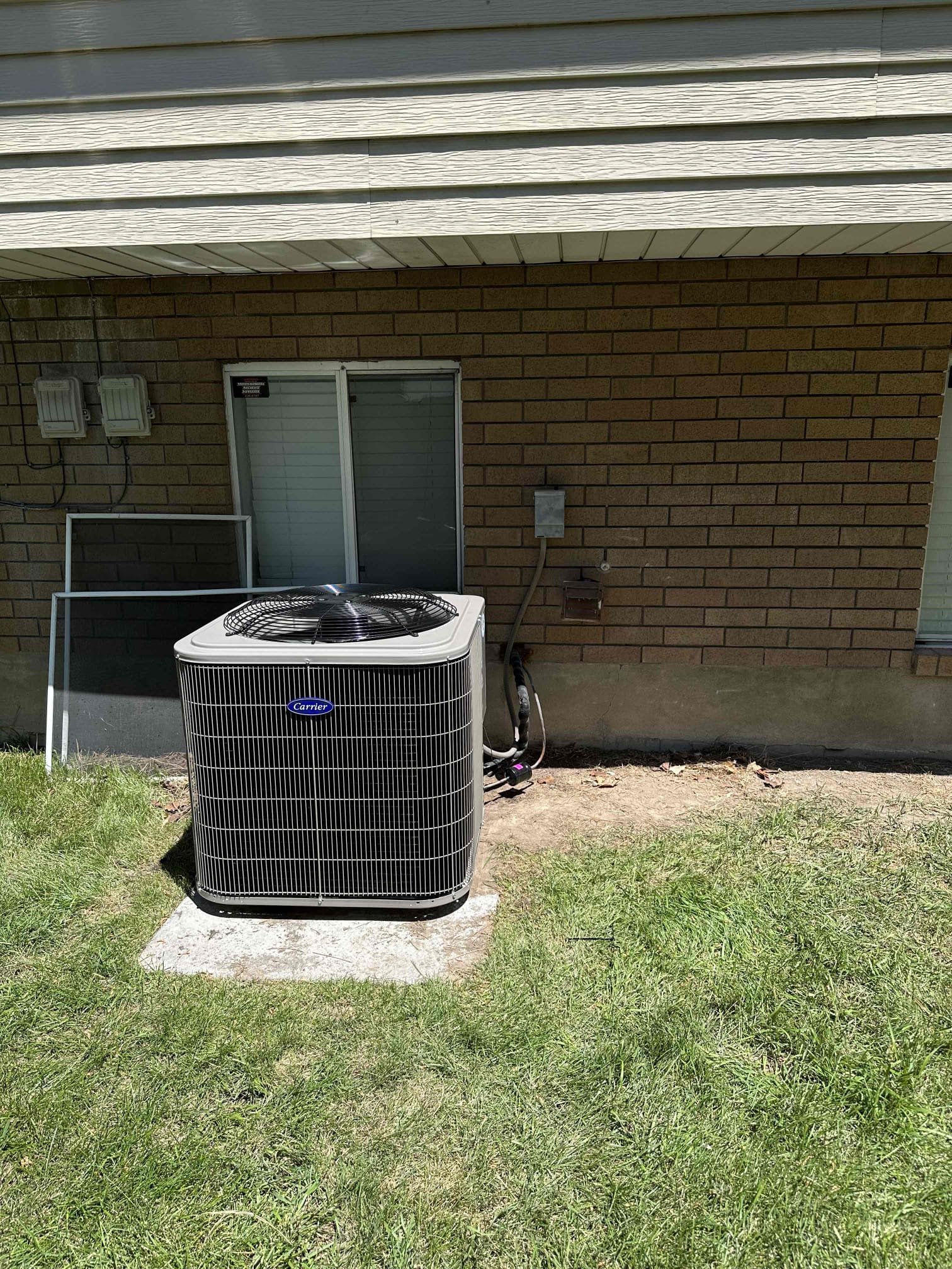 Clean, dry basement after storm; new Rheem water heater with easily accessible anode rod; fresh air blowing, suggesting odor removal. Shows cost-effective disaster recovery.