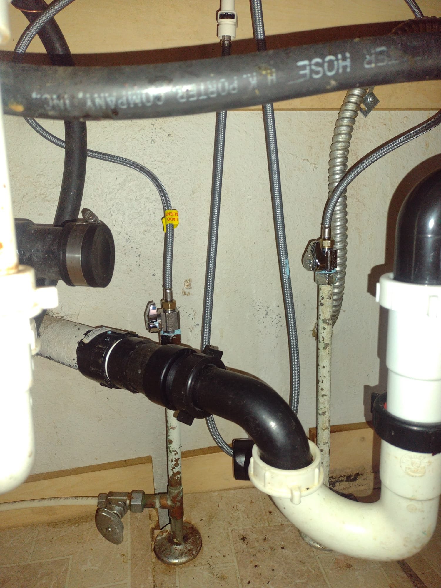 Image showcasing a pristine commercial office space with newly installed, smooth drywall. A subtle graphic overlay highlights pipes connected to a DIY soft water system, emphasizing its role in preventing future water damage. The visual contrasts sharply with a faded, water-stained drywall section in the corner, subtly reminding viewers of the costly alternative of neglecting water system maintenance and necessitating commercial drywall water damage recovery. The overall effect promotes proactive care over reactive repair.