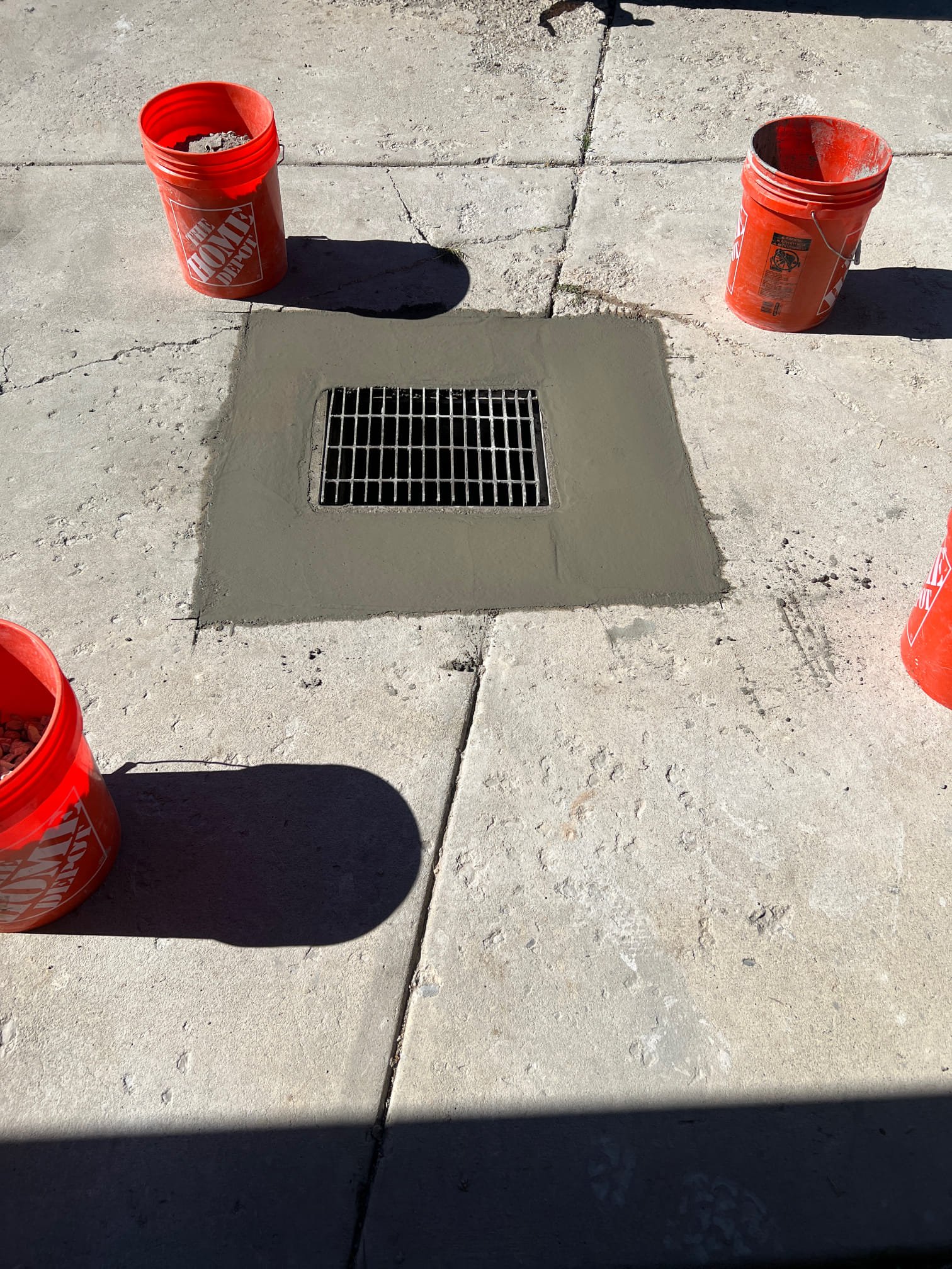 Image showcasing effective drain coverage: A lush, green lawn thriving above a properly installed French drain system. Clear water flows freely into the drain, highlighting its efficiency. A drain rooter tool is subtly displayed, symbolizing preventative maintenance and long-term drainage success.