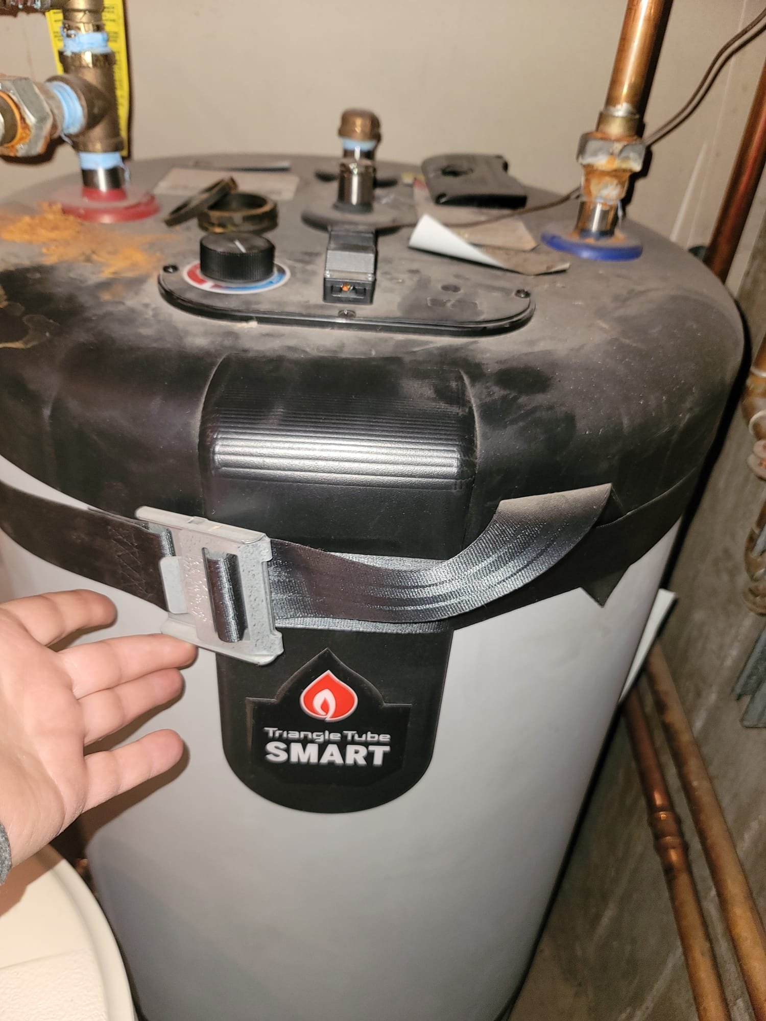Close-up of a Burnham residential boiler with clean, efficient flames visible through an inspection port, implying reliability and energy savings. A technician's hand is adjusting a dial, suggesting expert same-day or 24-hour tune-up service for optimal performance.