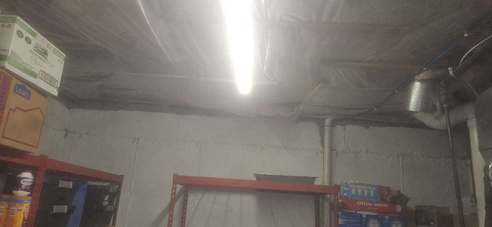 A sink plumber kneels, expertly installing a Pfister Pasadena faucet. The faucet's sleek, polished finish reflects the bright, clean space, highlighting its durability and modern design. The focused plumber emphasizes professional faucet service and a leak-free guarantee.