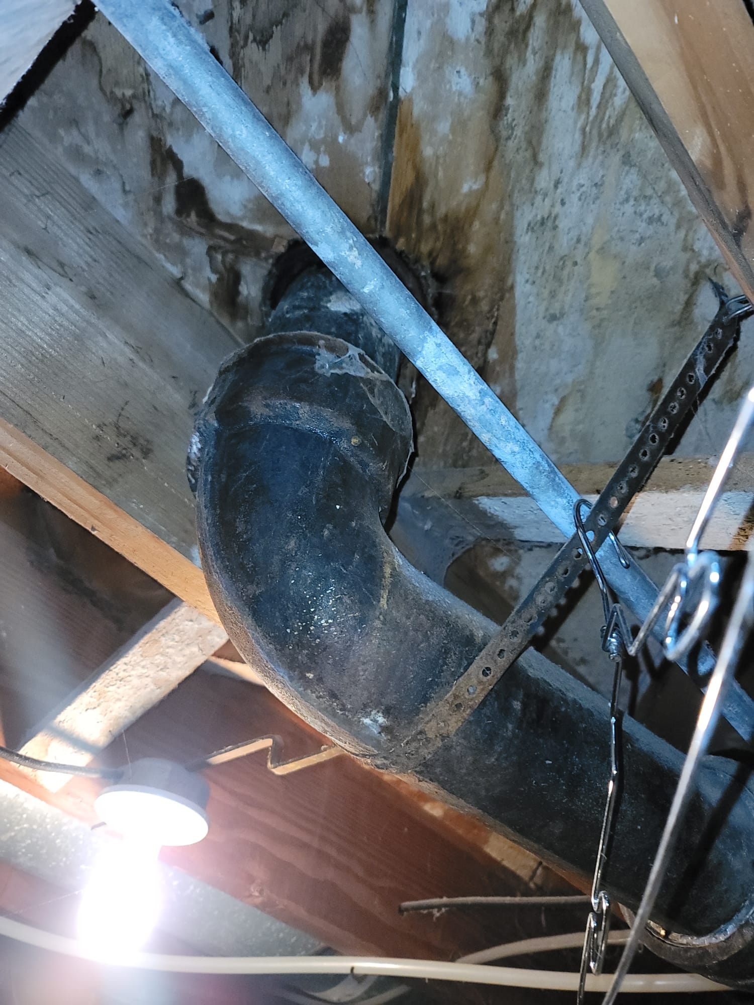 Close-up of a plumber expertly using a toilet snake to clear a blockage. The image highlights the tool's effectiveness in restoring proper toilet function, showcasing clean and efficient plumbing work.