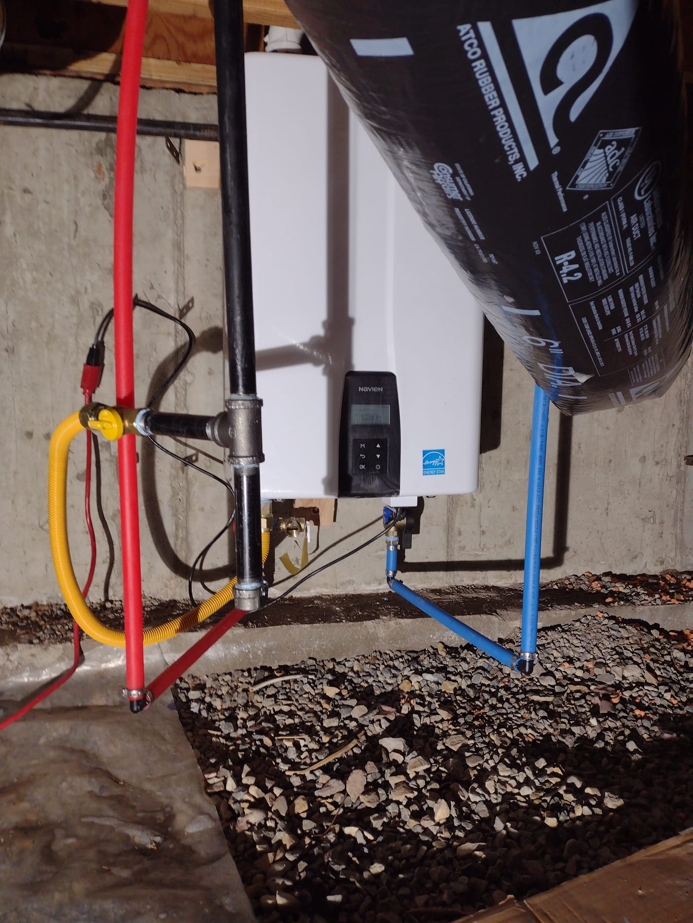 Dry, clean basement, post-flood repair, showcasing finished walls, new flooring, and a dehumidifier, suggesting a comfortable, livable space regained after water damage.