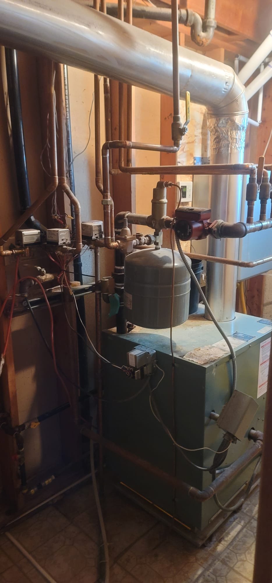 Close-up of a technician expertly repairing a commercial boiler, highlighting the clean, efficient design of a modern commercial condensing boiler. The image conveys reliability and minimized downtime.