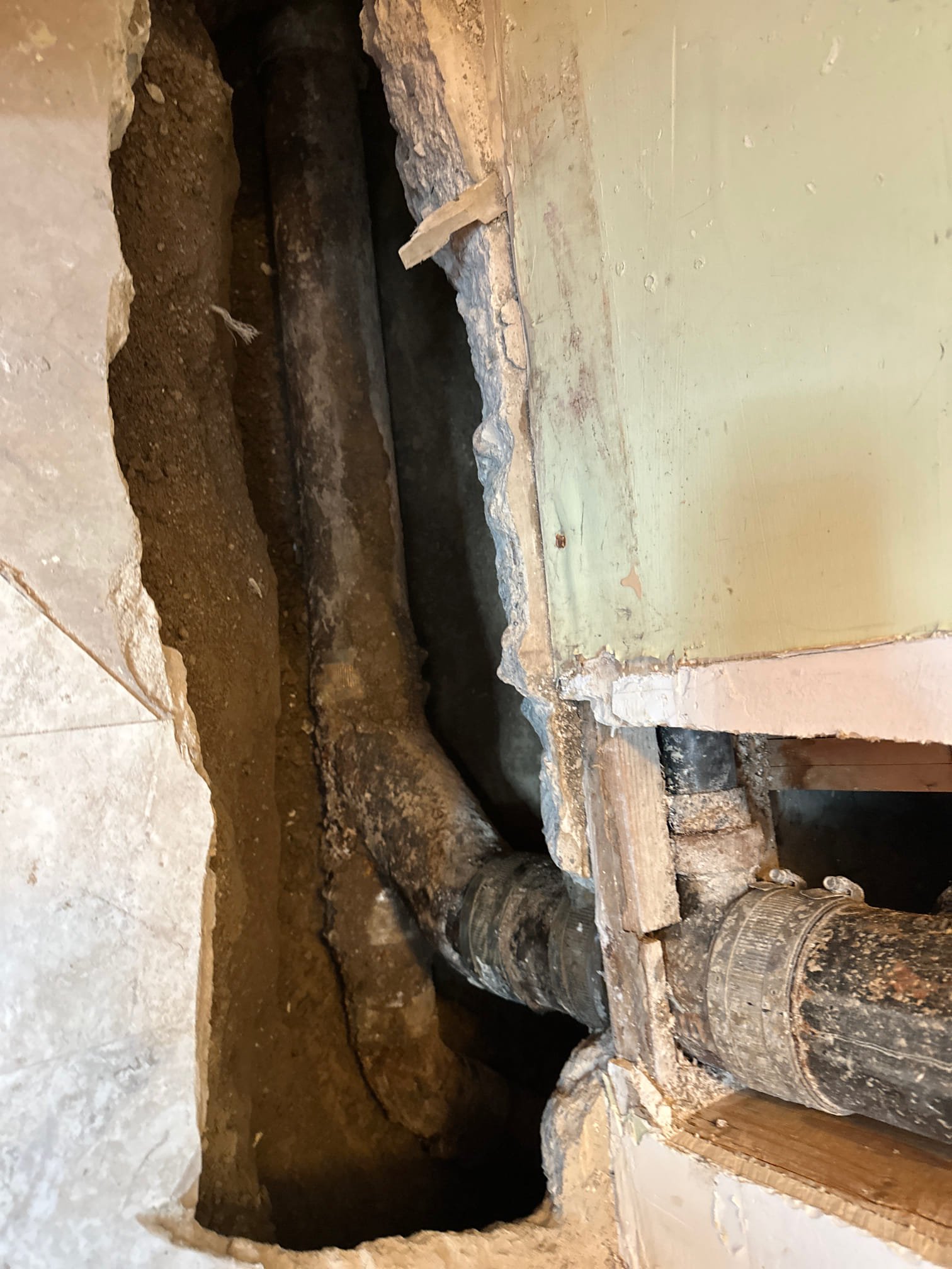 A brightly lit basement after flood recovery, showcasing clean, dry walls and new flooring. A technician is inspecting the space, likely providing a basement flood recovery diagnosis or estimate, emphasizing the benefits of an emergency basement flooding service.