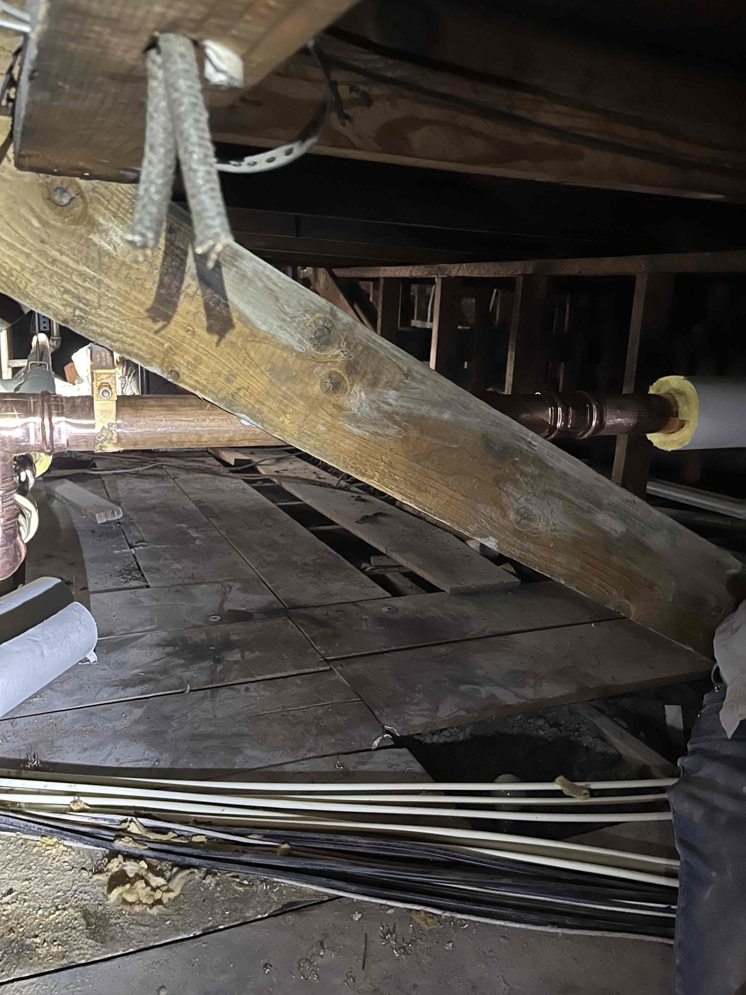 Commercial building interior with restoration crew using loud equipment for flood damage repair; dry, clean sections highlight effective, insured recovery.