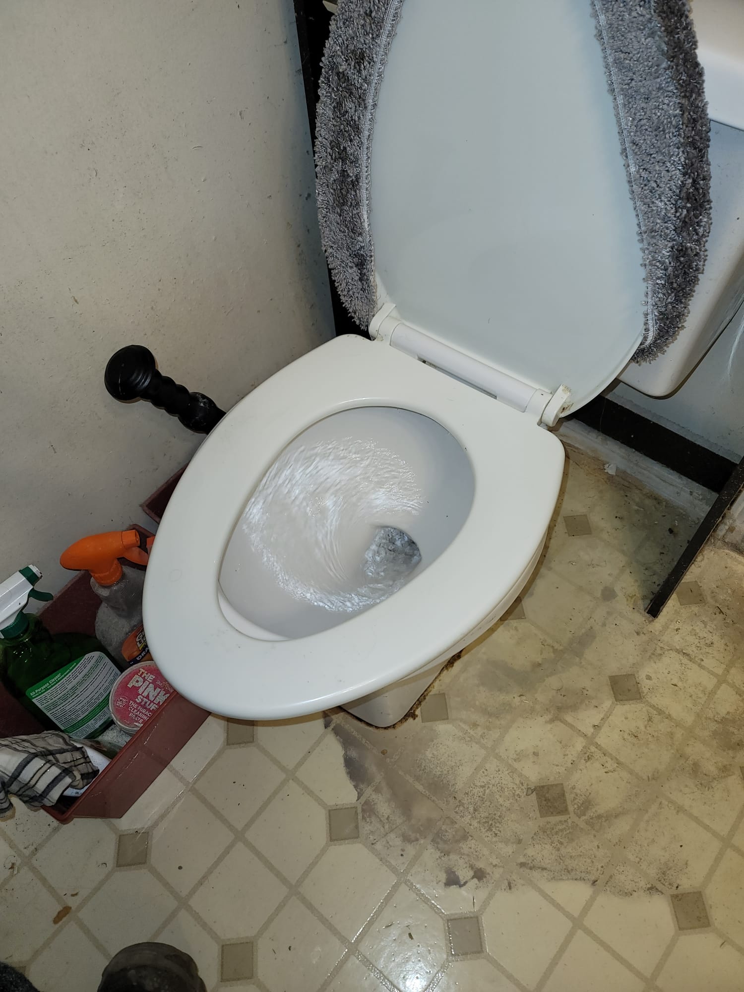 Image showing a toilet and shower pump system installed in a basement, designed to handle wastewater where gravity drainage isn't possible. Essential for basement bathrooms, this setup often integrates with universal toilet tank replacements and toilet fill valve replacement kits for optimal performance and easy maintenance.