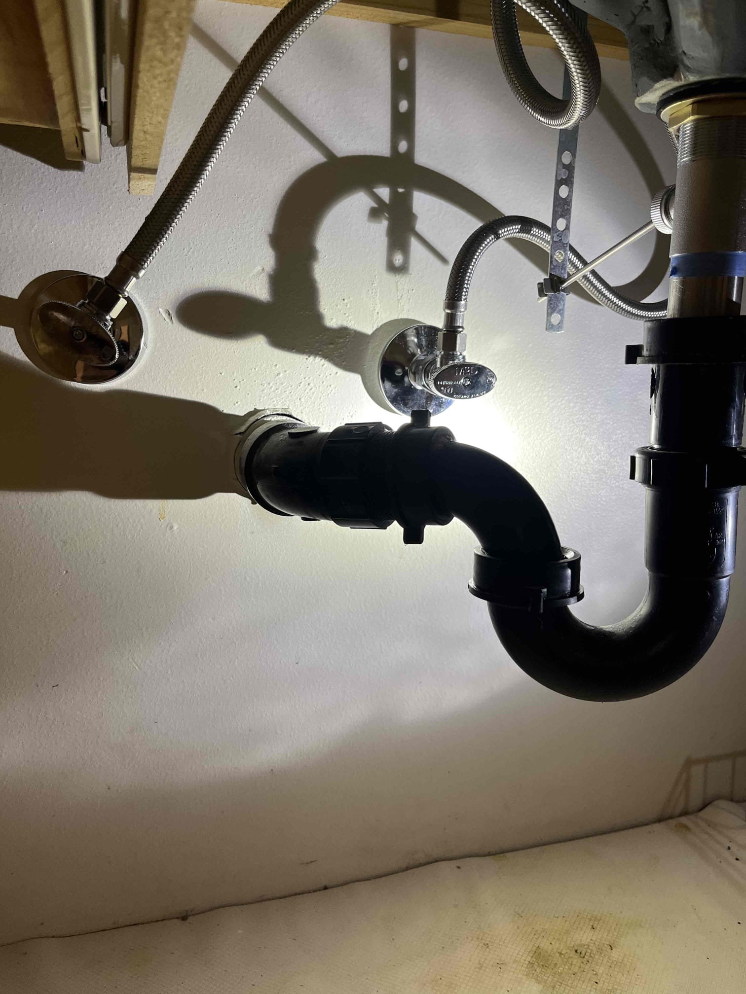 Newly installed, pristine sewer pipes gleam, promising efficient drainage and long-term cost savings. The organized installation site hints at professional sewer line installation, ensuring minimal future repairs and reduced sewer installation cost.