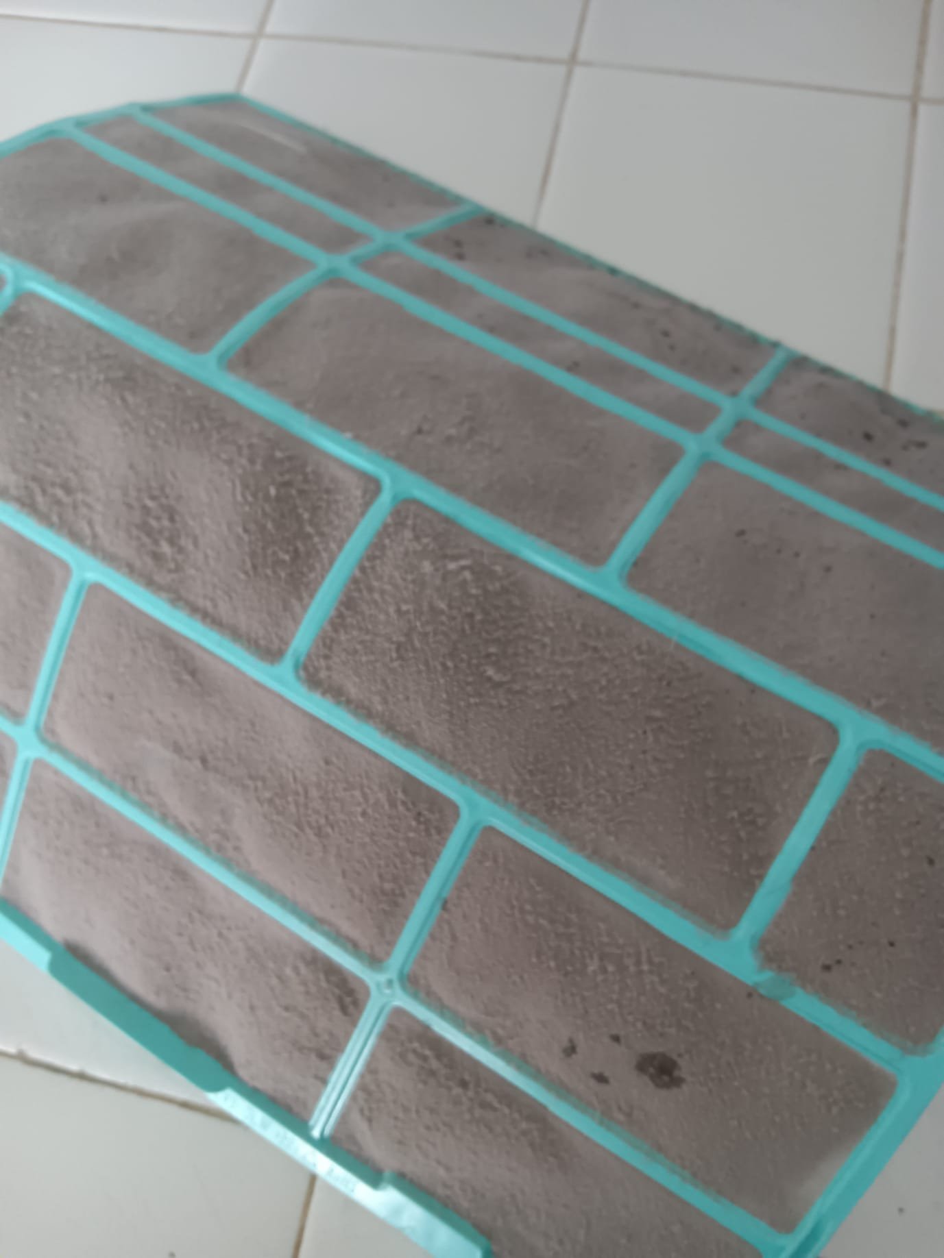 Workers in hard hats use heavy machinery to clear debris from a flood-damaged neighborhood. Bright sunlight illuminates the scene, highlighting the restored streets and rebuilt homes, showcasing the effectiveness of natural disaster recovery services and disaster recovery repair.