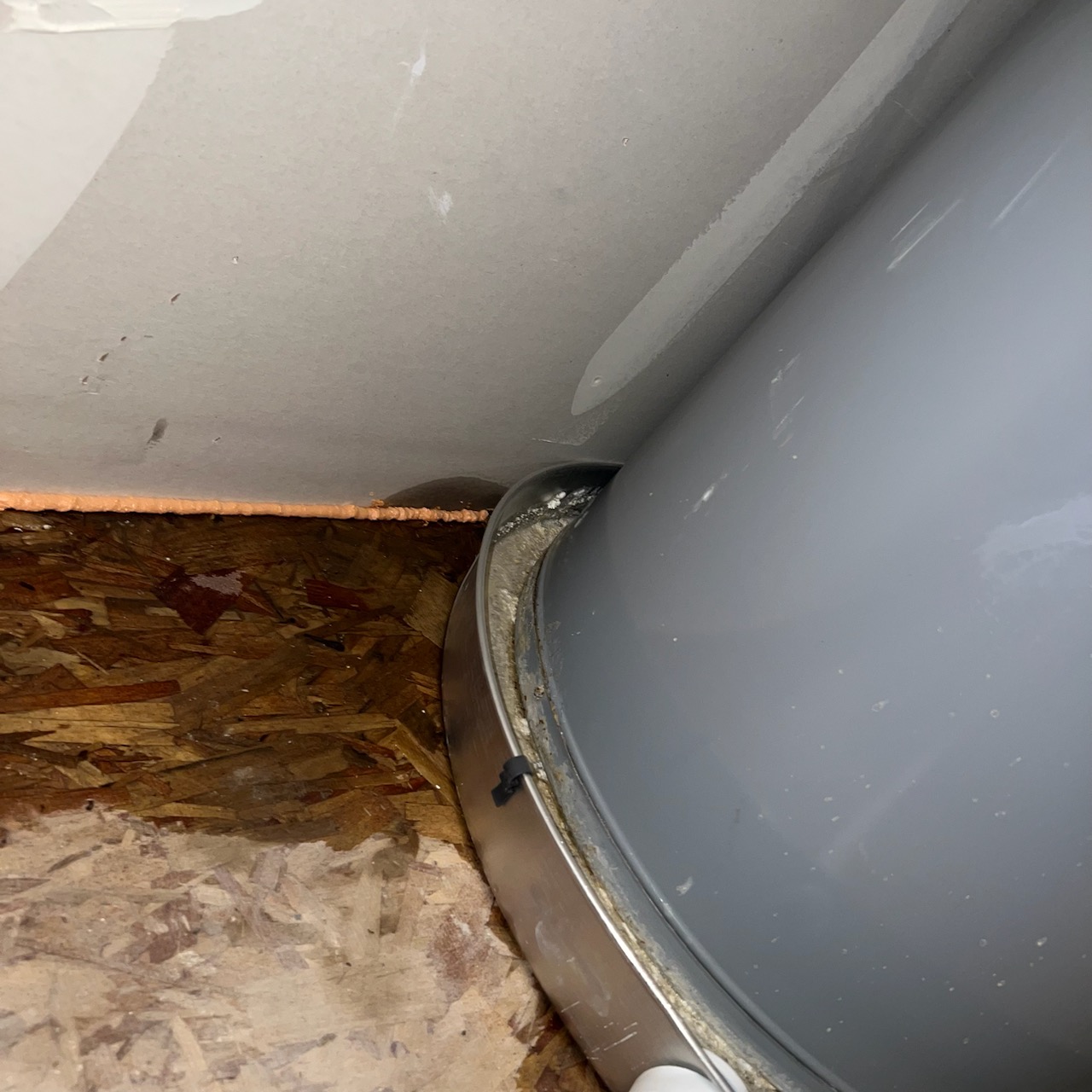 Clean, filtered well water flows into a clear glass, contrasting with a soot-stained ceiling corner. A modern water filtration system is subtly visible, promising fresh water and a clean home, free from odors and soot.