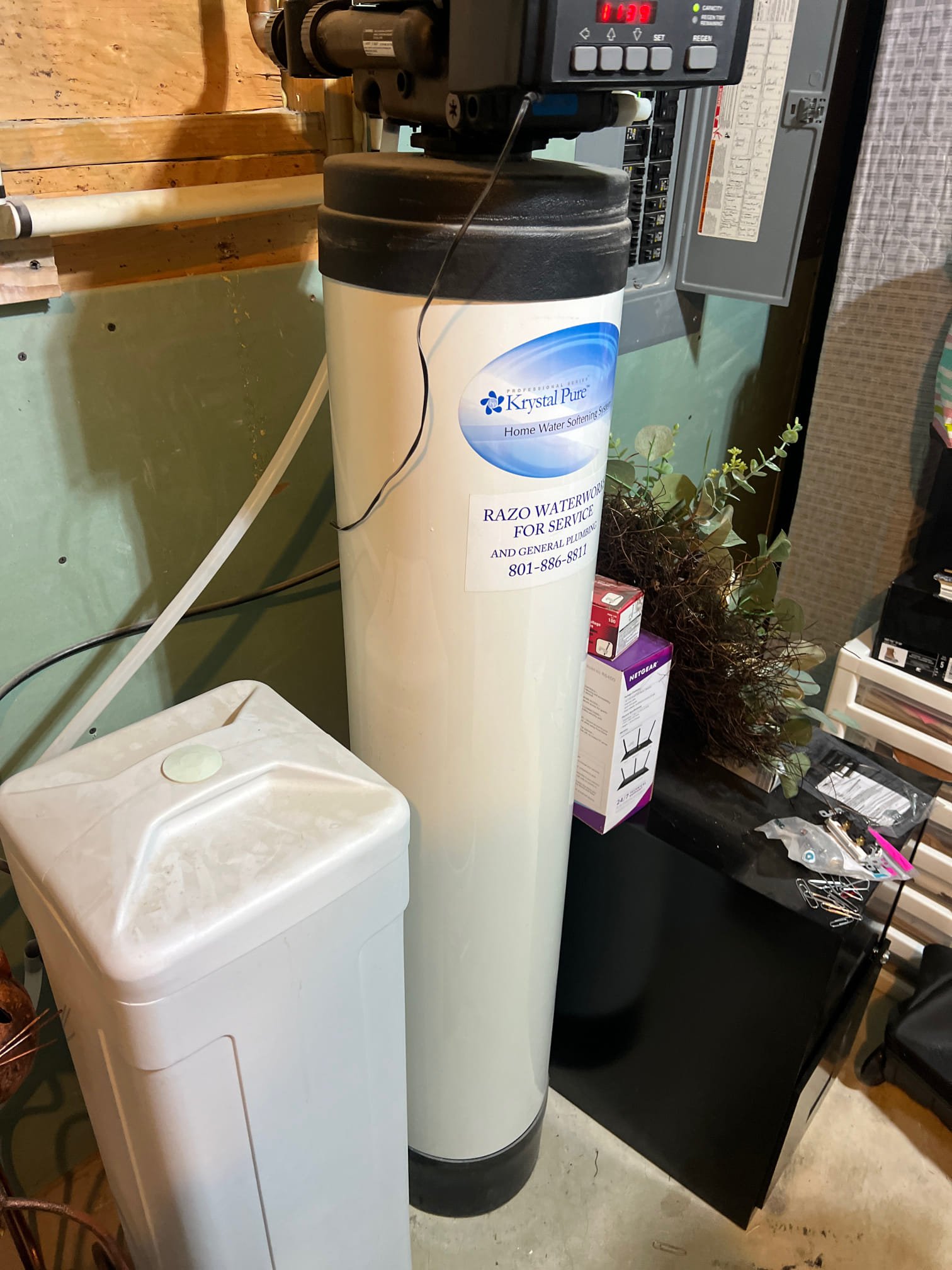 Image shows a water softener system with no soot marks, indicating proper maintenance. Clean pipes and connections suggest efficient operation and prevention of costly repairs, highlighting the benefits of regular water softener service.