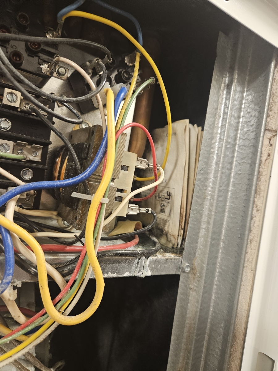 Close-up of a high-efficiency residential boiler's pressure relief valve. Essential safety feature for residential boiler repair, preventing overpressure and ensuring safe operation in modern heating systems.