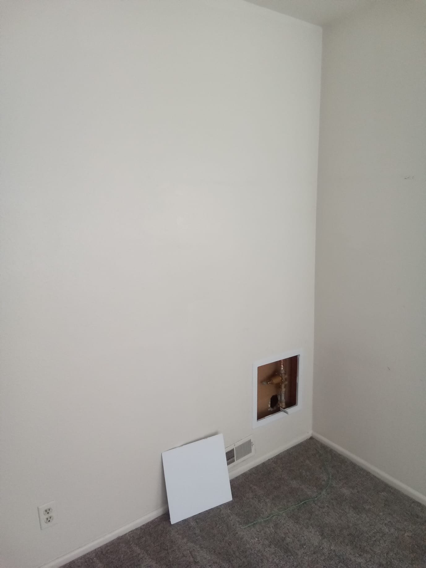 Bright, clean basement ceiling after water damage restoration. A modern water softener system nearby suggests the cause was addressed, preventing future issues. Professional restoration ensures a safe, affordable, and visually appealing result.