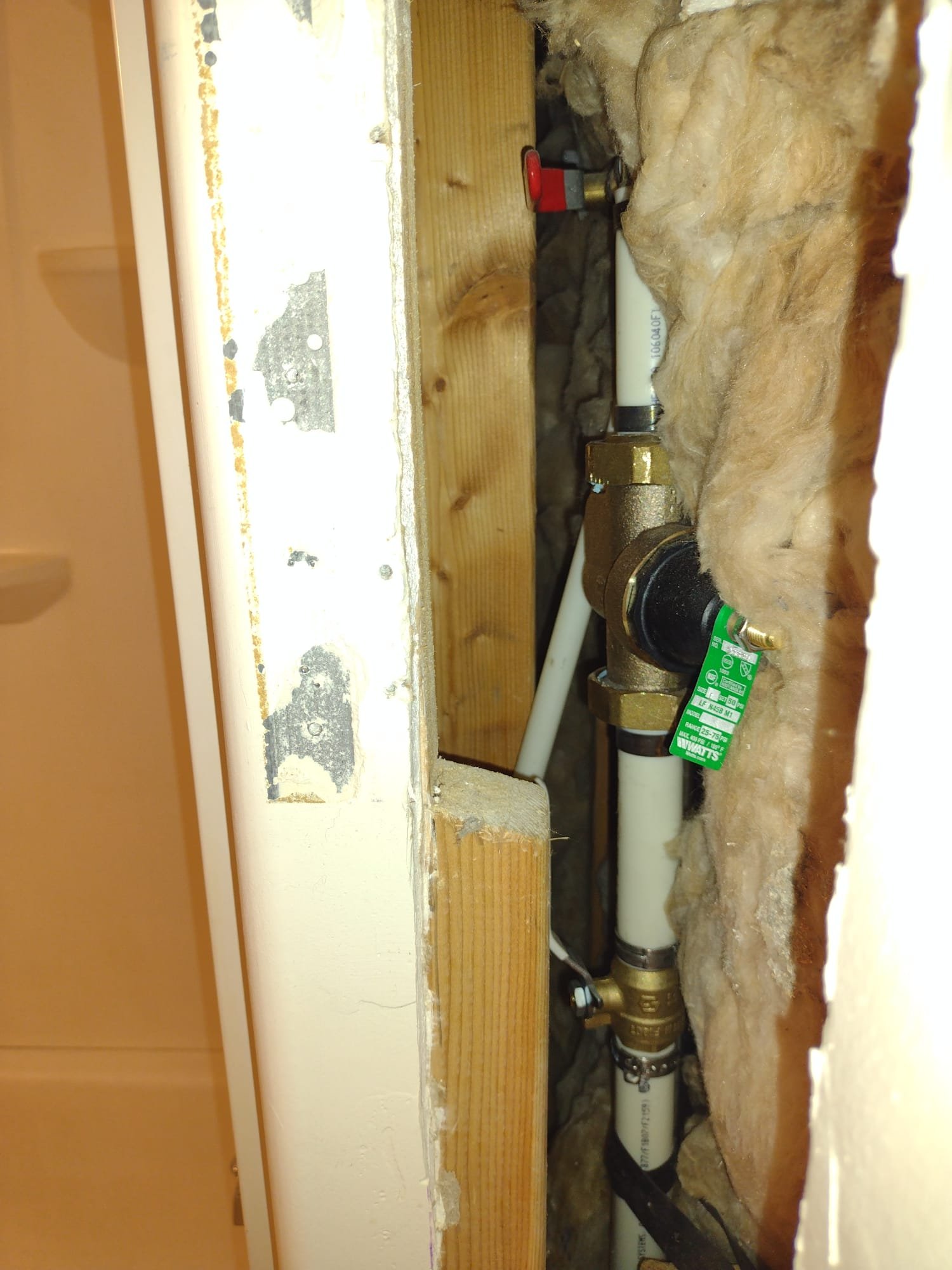 Close-up of various plumbing leak repair products, including epoxy putty, pipe clamps, and sealing tape. A repaired water pipe with no visible leaks demonstrates effective water leak repair. Clean and dry surroundings suggest easy application and immediate results, relevant for 'water leak repair near me'.