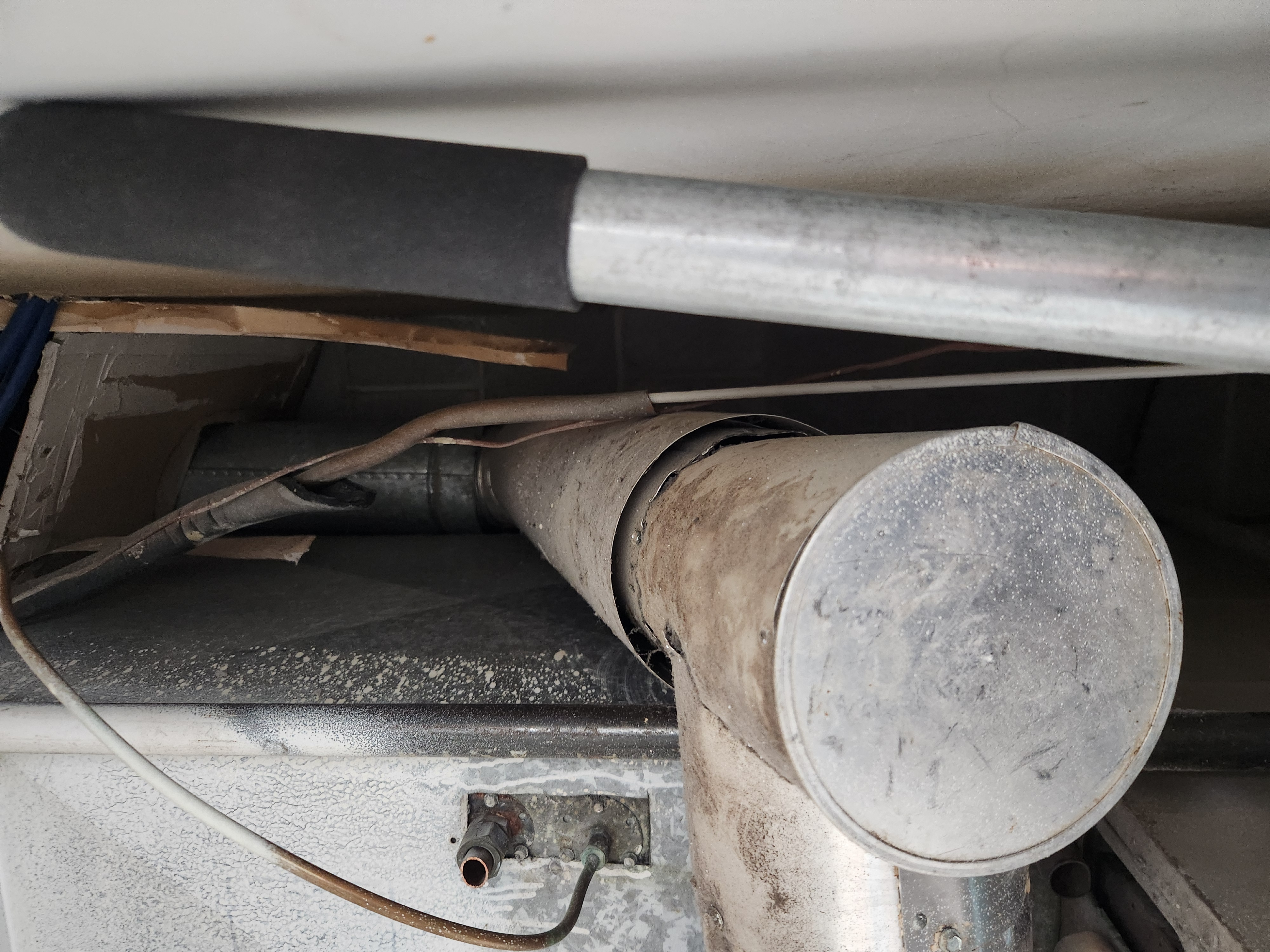 Close-up of a clean furnace filter beside a well-maintained residential furnace. The image highlights the importance of regular furnace filter replacement for efficient furnace operation and maintenance, implying cost savings and improved air quality.