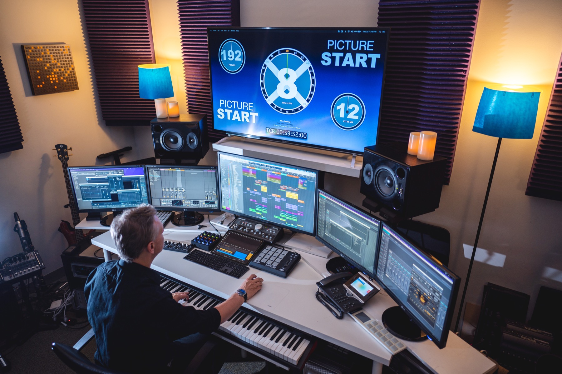 Chris working at the keyboard and multi-screen music production desk in Studio B, the city studio.