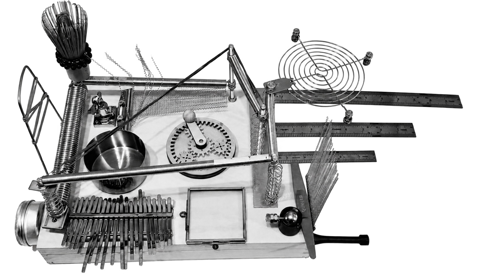 Custom-built noise instrument with springs, metal rulers, tines, and resonant objects