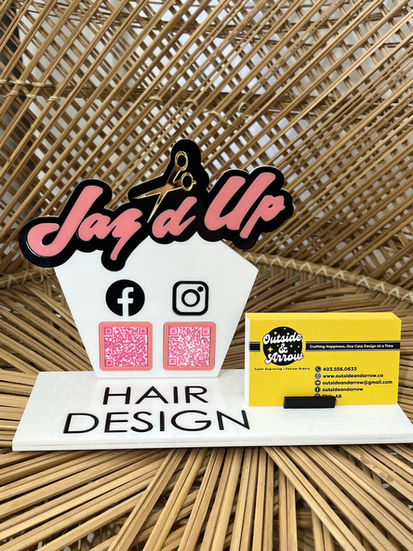 Market stand with pink, white, black and gold acrylic with two barcodes to link to the business and a spot for their business cards.