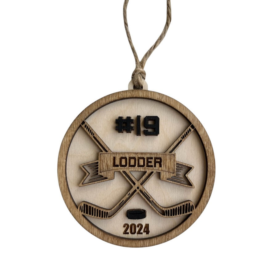 Custom wooden holiday ornament featuring hockey sticks and family name