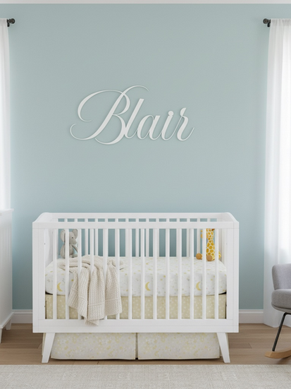 Cutout acrylic name sign - Blair. Made from white cast acrylic in a nursery with a white crib and blue wall.