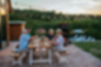 people eating in a perfect backyard with a shed in the background