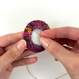 Whip stitch embroidery around fussy cut brooch edge