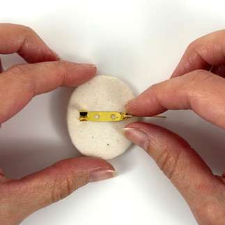 Adding pin back to backing of brooch