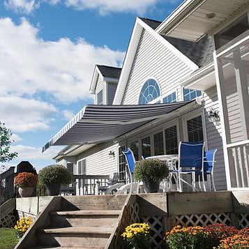 Motorized retractable awning providing shade for commercial storefront by Glendale Awning Company