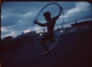 An acrobat in an iron, giant hoola hoop type structure. 