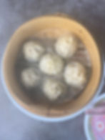 Steaming Shanghai pork dumplings in bamboo baskets