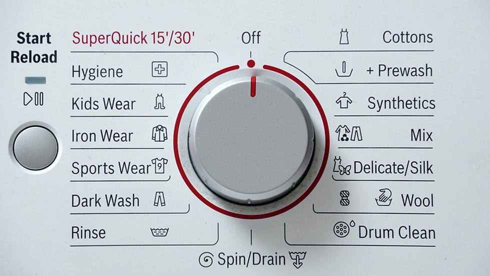 Eye-level view of a modern washing machine control panel with cycle options