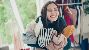 Smiling girl holding laundry