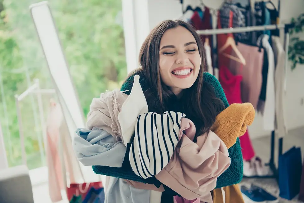 Smiling woman holding laundry