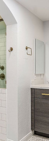 This bathroom remodel blends rustic charm with modern amenities. Wood-look tile flooring, matte black fixtures, and a frameless glass shower create a warm, inviting atmosphere that’s both stylish and functional.