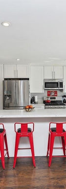 This remodel features custom-built storage solutions, a durable tile backsplash, and easy-to-clean flooring—perfect for a busy household. The open floor plan makes cooking and entertaining effortless.