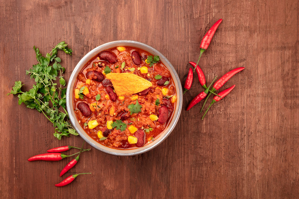 Vegetarian chili with onions, red peppers, carrots, celery, tomatoes, beans, chick peas and corn.