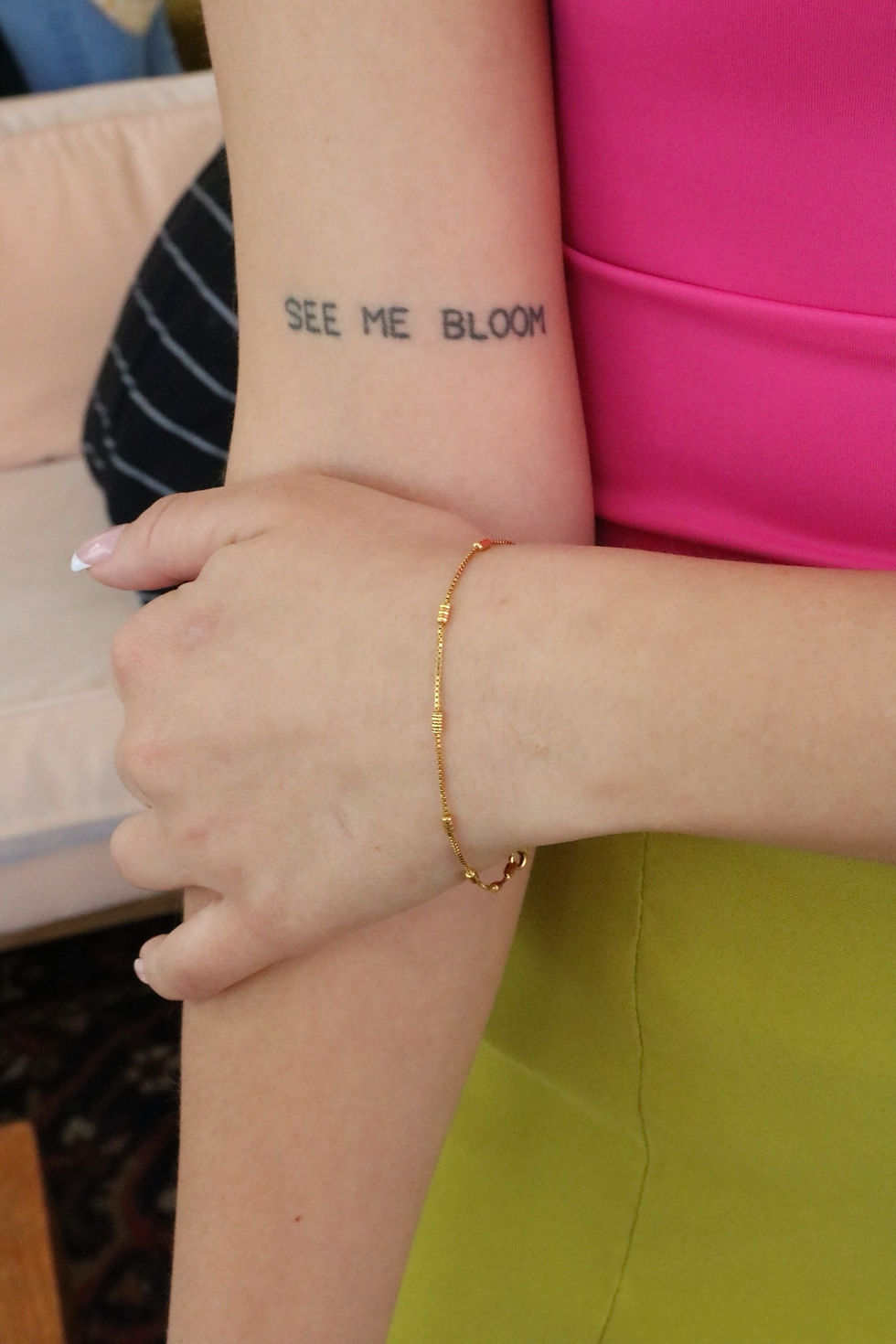 Fair skinned person wearing a 21 karat solid gold chain bracelet with ruby