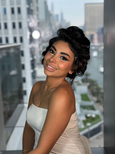Smiling woman with stylish hair, city view