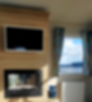 TV on the wall above electric fireplace