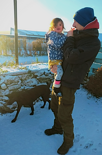 Ali and younger daughter and labrador in the snow