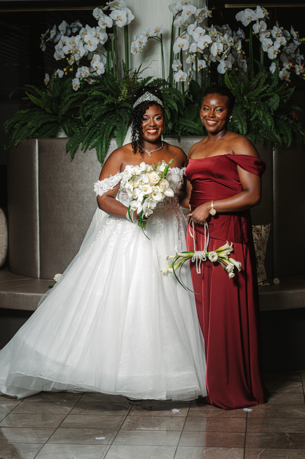 Ramarra and a bridesmaid holding white bouquets at Laurel Manor.