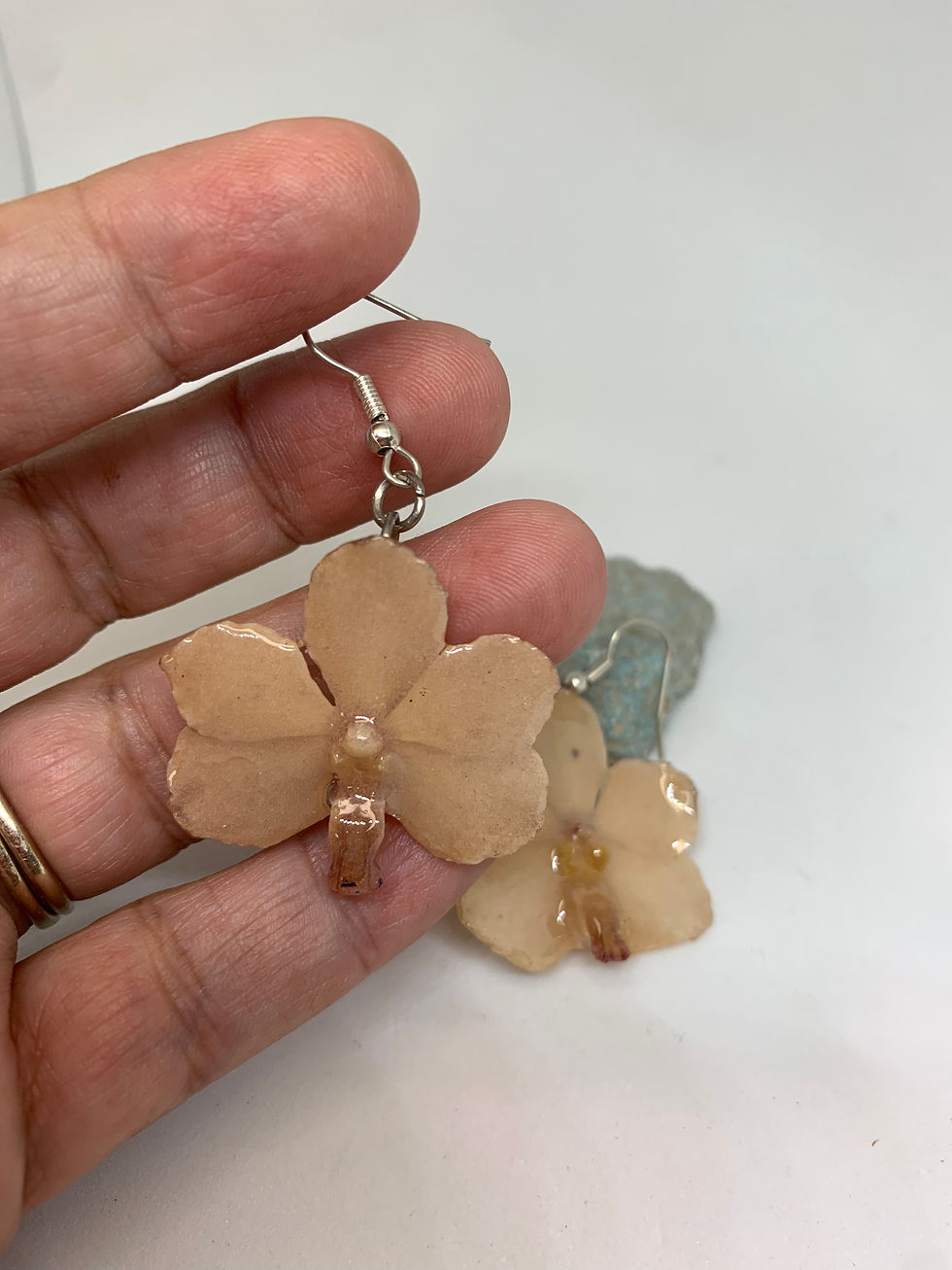 Close-up view of natural orchid earrings with delicate petals