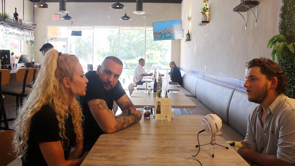Simona and Andrea Sarpa of Sogna Napoli in Carrollwood speak with Chuck Merlis of Tampa Stories inside their restaurant.