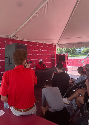 Chuck Merlis recording Buccaneers head coach Todd Bowles during a post-practice press conference at Tampa Bay training camp.