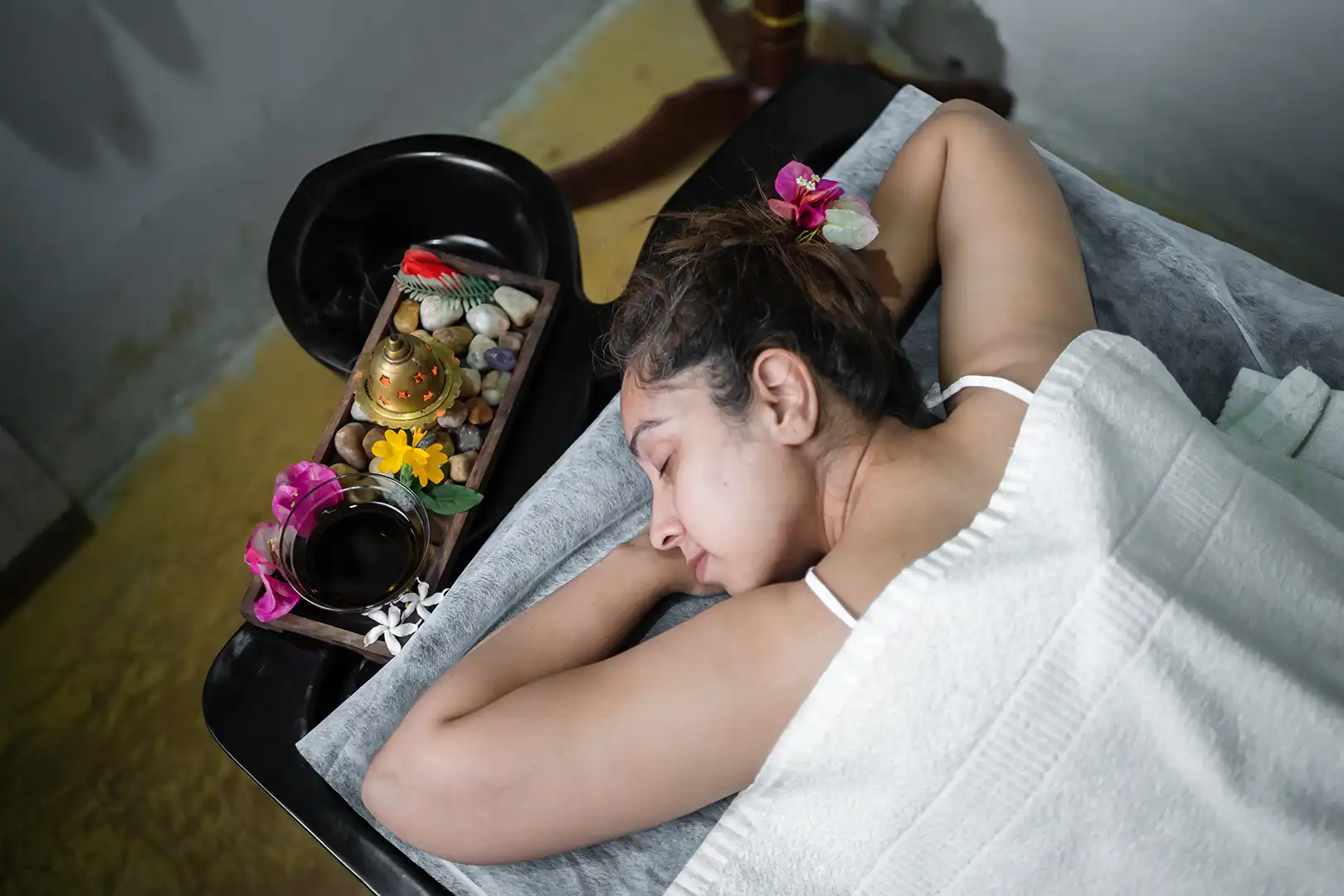 Woman enjoying ayurveda massage at yoga retreat conducted by satvan yoga, goa