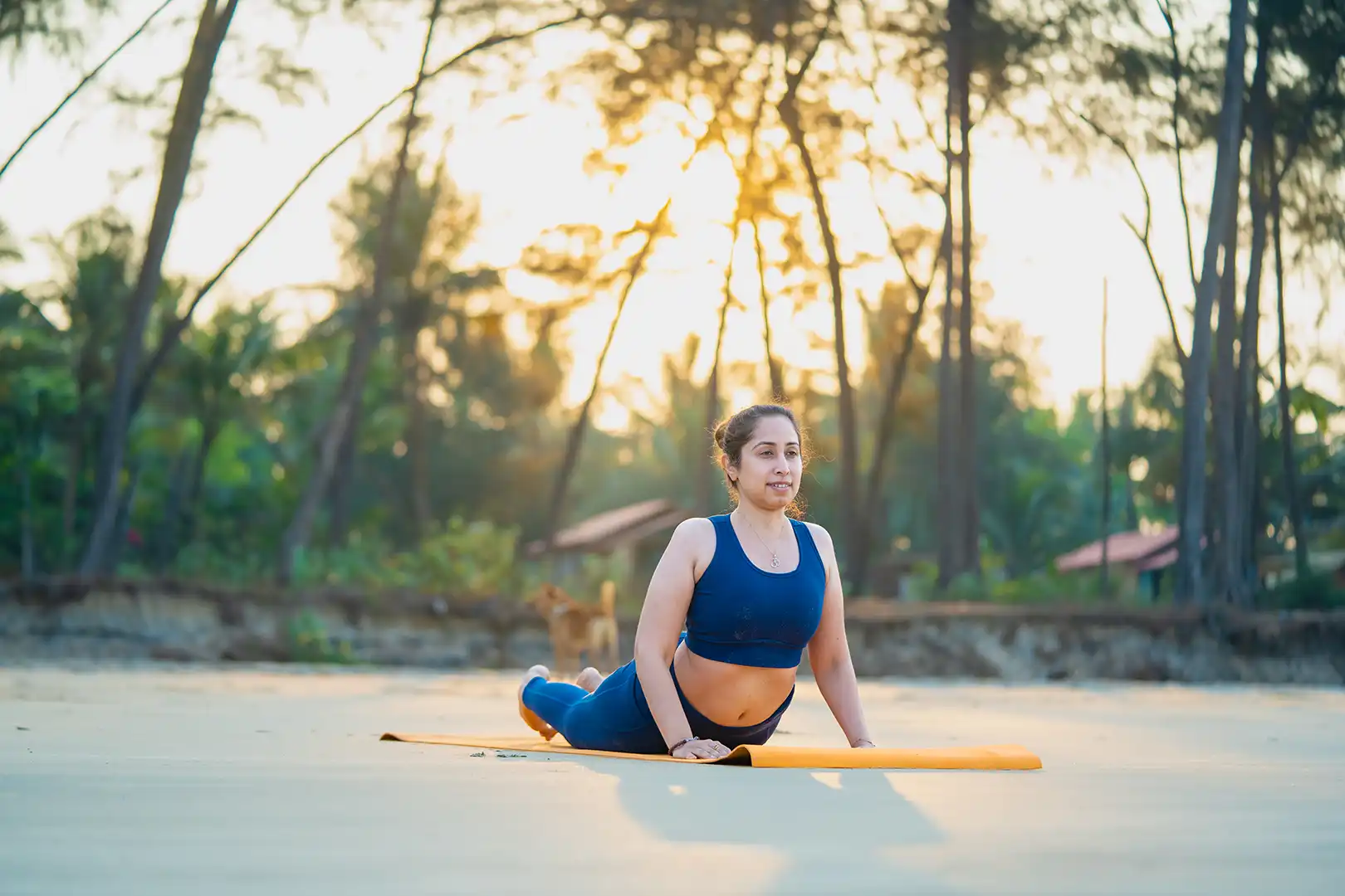 stuti asher from satvan yoga in yoga pose on beach in goa