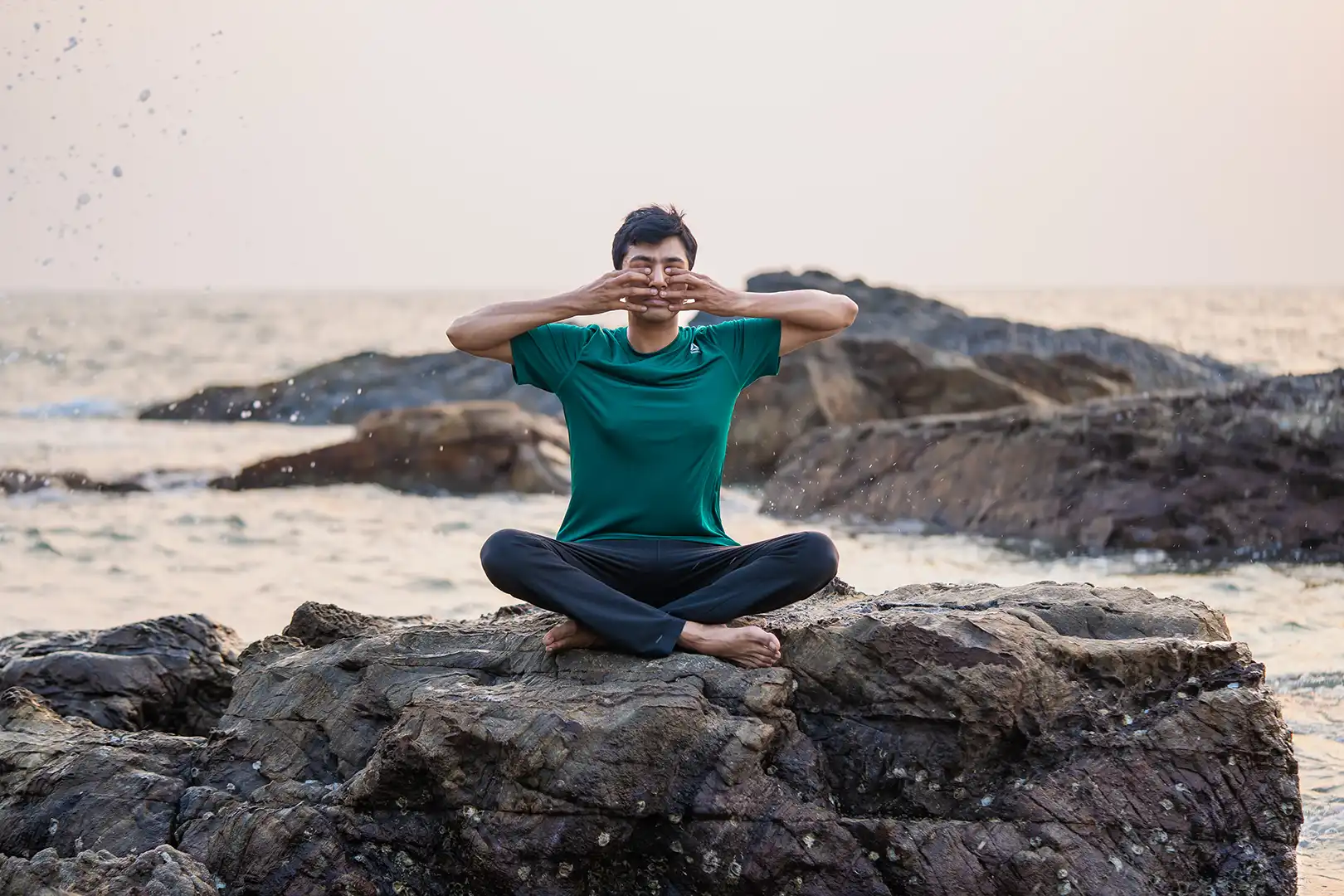 rohan shroff from satvan yoga, goa practicing yin yoga on the beach