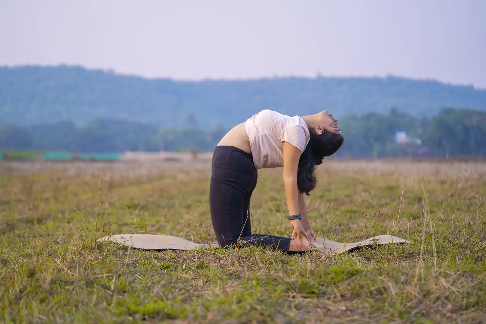 pradnya from satvan yoga, goa practicing yoga in open field